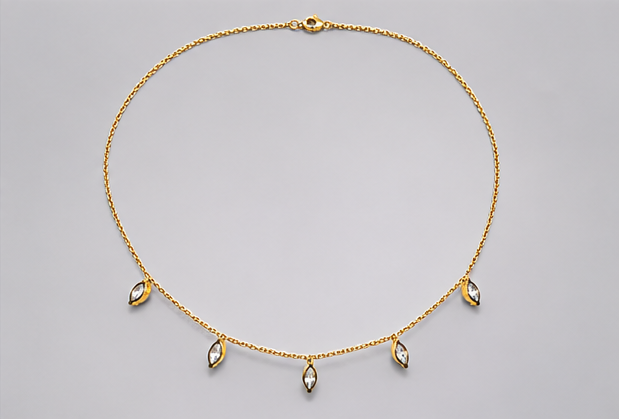 Full circular layout of SEELE gold-tone chain necklace with five dangling clear marquise-cut crystal charms.