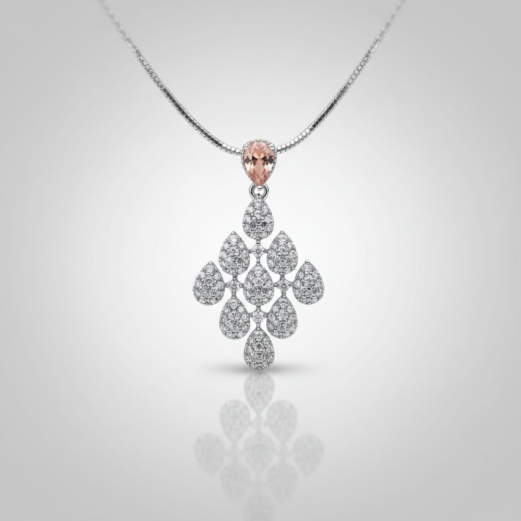 A silver-toned diamond pendant necklace with a marquise-cut pink gemstone at the top and a teardrop-shaped cluster of diamonds below.