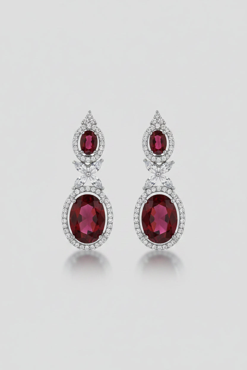 SEELE Crimson Halo Drop Earrings — deep red oval zircon drops with clear stone halo on silver base