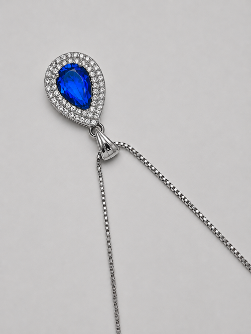 Royal blue teardrop crystal pendant necklace with sparkling clear stones and a silver-tone setting on a delicate chain.