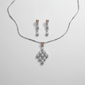 A jewelry set featuring a silver-tone chain necklace with a floral pendant and matching drop earrings.